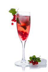 Red drink or cocktail in a glass for champagne isolated on white with red currant