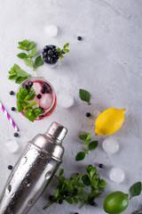 Ingredients for making lemonade  , Mojito Cocktails or other drinks with blueberry on a gray concrete background