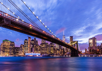 Naklejka na ściany i meble Brooklyn Bridge with skyscrapers background. New York City, USA. Brooklyn Bridge is linking Lower Manhattan to Brooklyn..