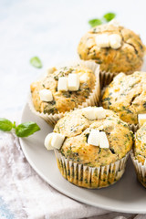 Freshly baked muffins with spinach and feta cheese. Light background. Copy space.