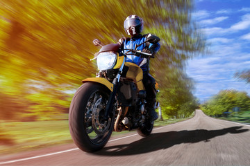 motorcycle riding on highway through countryside. fast motorbike on empty country road rider enjoys...