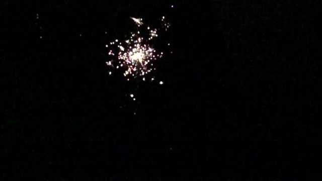 Slow motion of a sparkler with a black background medium shot.