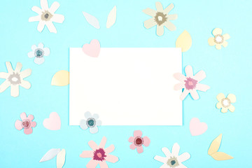 Empty card with spring, easter decoration over blue pastel backgroung