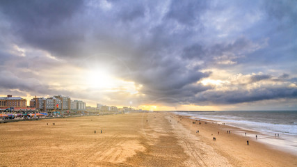 Beautiful seaside landscape - view of the beach near the embankment of The Hague with people making...