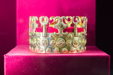 Gold and jewell-studded King's crown close-up in the gallery