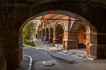Arched passage to the courtyard and the old brick colonnade