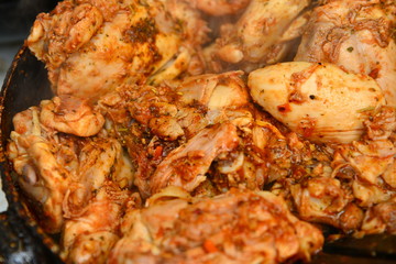 Fried chicken with spices in a pan