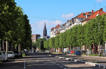 Obraz premium Strasbourg street perspective with monumental Cathedral in the background