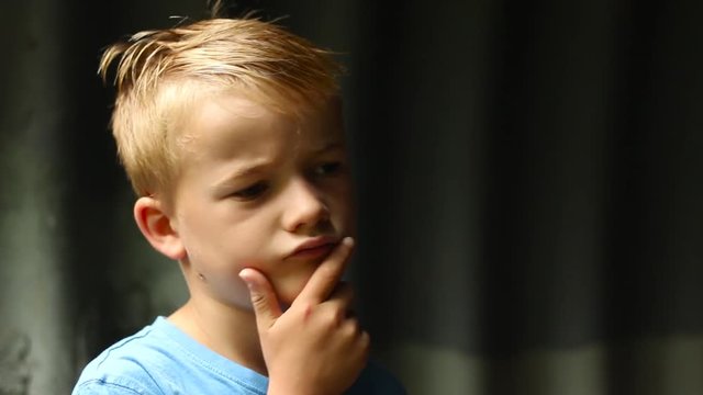 Attractive Caucasian boy thinking, CLOSE UP