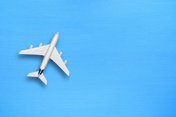 Model of modern plane on blue table