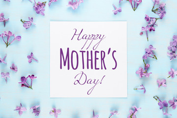 Naklejka premium Mother's day card with lilac flowers on blue background