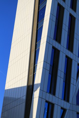 Sharp angled side of a tower block.  Close up of an angled side of a tall tower block in an English city.