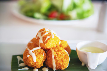 Fried mozzarella cheese ball ready for eat - delicious colourful food concept
