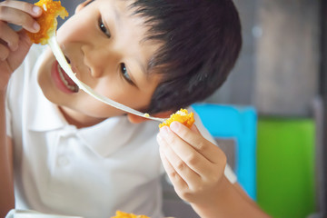 Boy ready to eat sticky stretch fried cheese ball - people and delicious cheese food concept