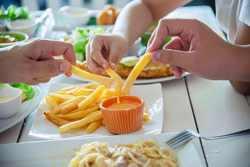 Family time eat French fries together - family life with food concept