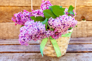Ecology nature springtime concept. Bouquet of flowers beautiful smell violet purple lilac in vase on rustic wooden background. Inspirational natural floral spring blooming garden or park