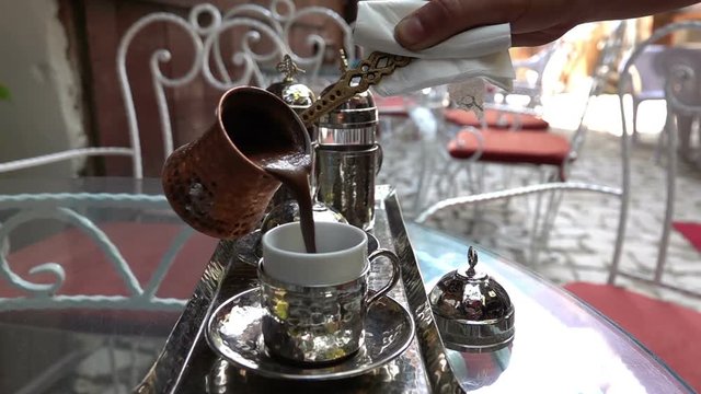 Turkish Coffee poured into the Turkish coffie cup - Slow Motion