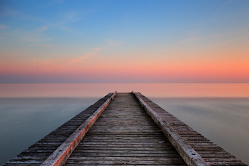 Fototapeta na wymiar Pontile sul mare di Jesolo al tramonto