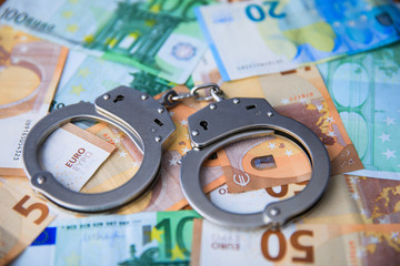 handcuffs on money