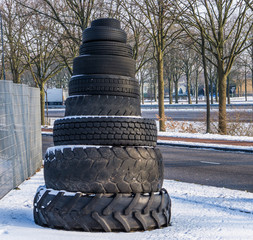 tower of stacked tires in all kinds of sizes and shapes, beautiful outdoor decoration