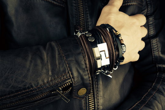 Hand of rocker in leather  bracelet and accessory .Hard rock, heavy metal,gothic and punk style.Brutal jacket