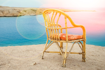 Stylishly beautiful chair on the sea nature landscape background