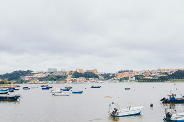 Fototapeta na wymiar 30 April 2016 - Porto, Portugal: Beautiful view to Porto city with fishing boats and beautiful architecture