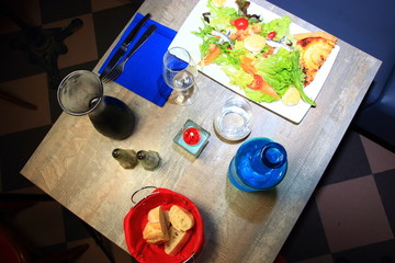 Table of a french restaurant with salad starter and bread