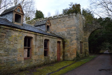 Fototapeta premium Ruined buildings at the entrance to the striking ruins of Crawford Priory, Springfield, Cupar, Fife, extended in early 19th century.