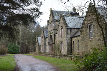 The refurbished stable block at the entrance to the striking ruins of Crawford Priory, Springfield, Cupar, Fife.