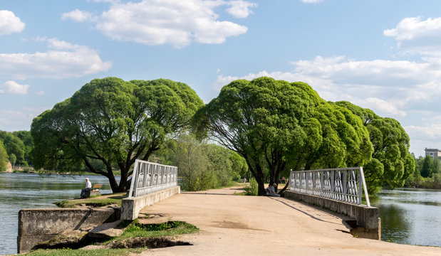Narva River Promenade, foot bridge with trees on a sunny day. Estonian, Russian border.  