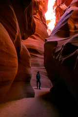 Impressed young traveler woman wondering inside of the Antelope Canyon, Arizona, USA. 