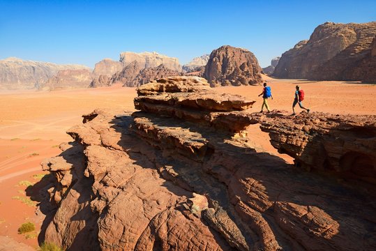 Couple hiking at Rock Arch, Al Borg Alsagheer, Wadi Rum, Jordan, Asia