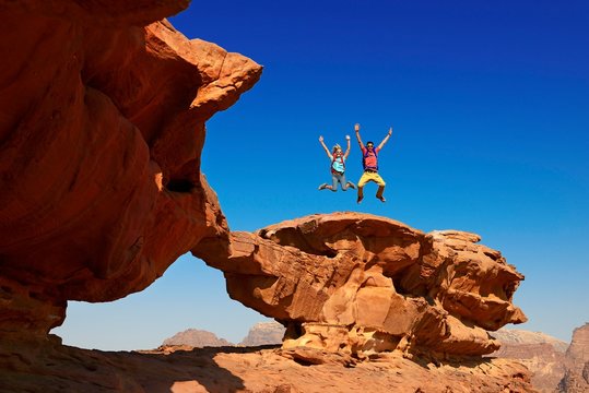 Couple hiking at Rock Arch, Al Borg Alsagheer, Wadi Rum, Jordan, Asia