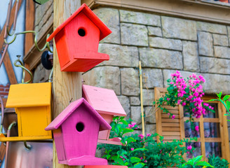 Multicolored nesting boxes outdoor background