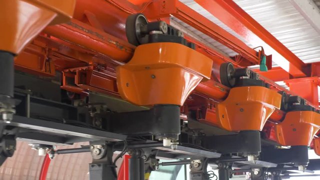 Close up roller coaster mechanism. Machinery coming and going.