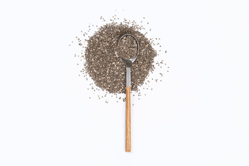 Chia seeds in a spoon on white background. Flat lay. Top view