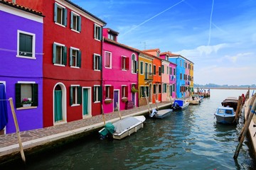 Fototapeta na wymiar Vibrant houses along a canal on the colorful island of Burano near Venice, Italy