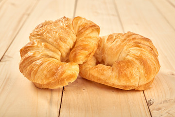 fresh baked croissants on wooden table