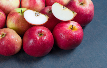 Fresh organic ripe red apples with water drops on wooden background, Apple fruit concept