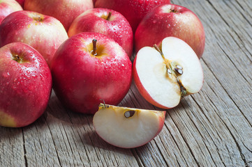 Fresh organic ripe red apples with water drops on wooden background, Apple fruit concept