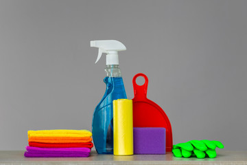 Colorful set of tools for cleaning the house on neutral . The concept of spring cleaning. Place for text.