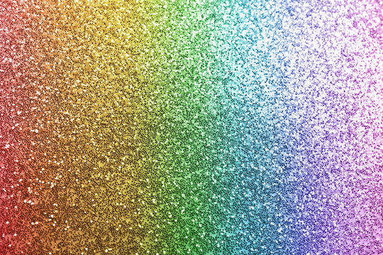 Composition of sparkling rainbow glitter as background, top view