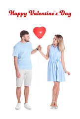 Young couple with heart-shaped air balloon on white background. Celebration of Saint Valentine's Day