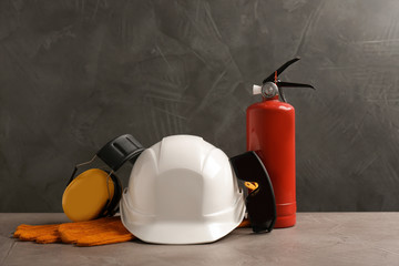 Composition with safety equipment on table against grey background