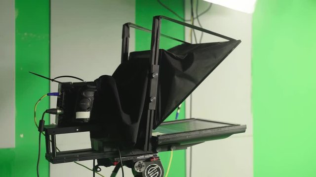 professional camera with teleprompter in green screen studio