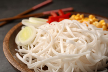 Plate with rice noodles and vegetables, closeup