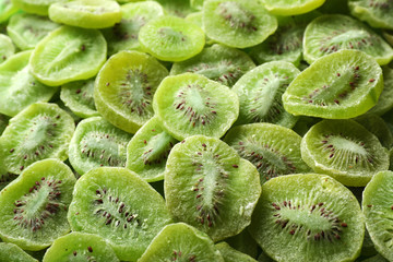 Naklejka na ściany i meble Tasty slices of kiwi as background, closeup. Dried fruit as healthy food