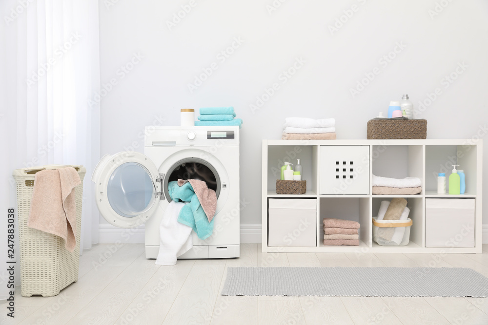 Wall mural Bathroom interior with towels and washing machine