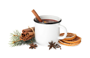 Composition with mug of mulled wine, cinnamon, orange and fir branch on white background